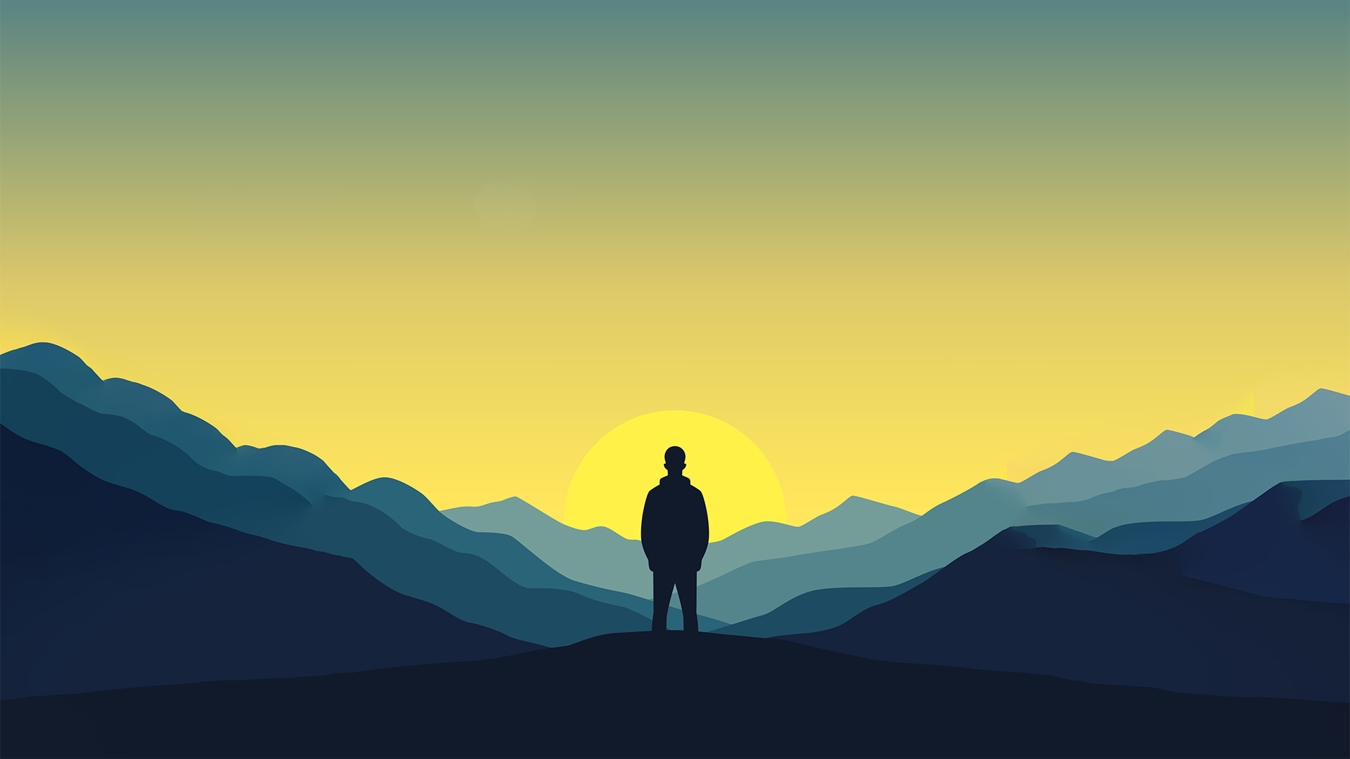 Silhouette of a person standing on a hill with mountains and a yellow sunrise in the background.